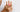 An elderly woman holding her fingers in discomfort, reflecting the importance of caring for long-term joint health.